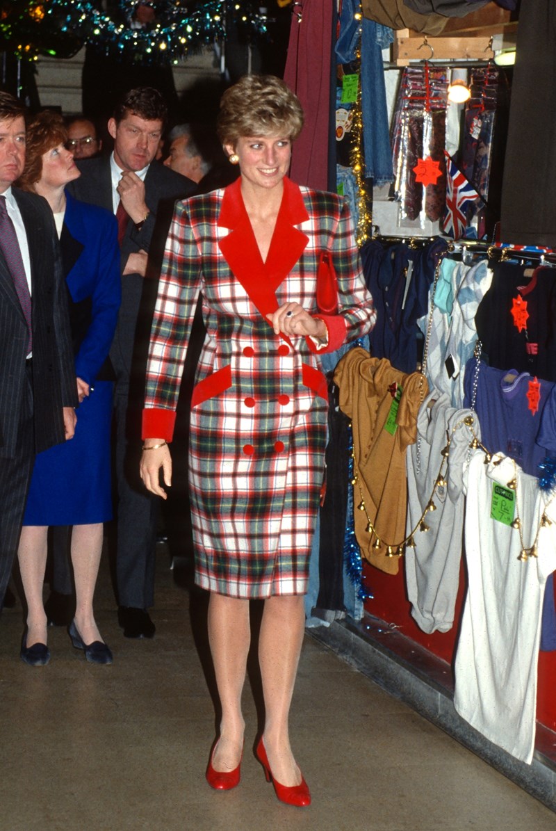 Diana, Princess of Wales, wearing a red and green tartan coat dress designed by Catherine Walker with red heels, opens the The Galleries shopping centre on November 25, 1991 in Wigan, United Kingdom.